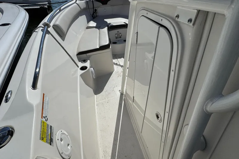 Slide: The Image of 2022 Sailfish 242 CC boat interior with seating and storage compartment. - 17