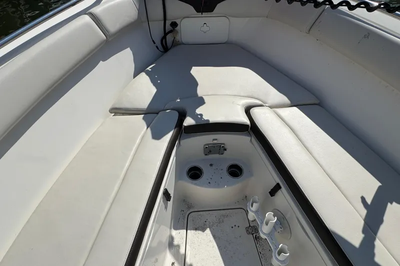 Slide: The Image of Interior of 2022 Sailfish 242 CC boat with cushioned seating and storage compartments. - 19