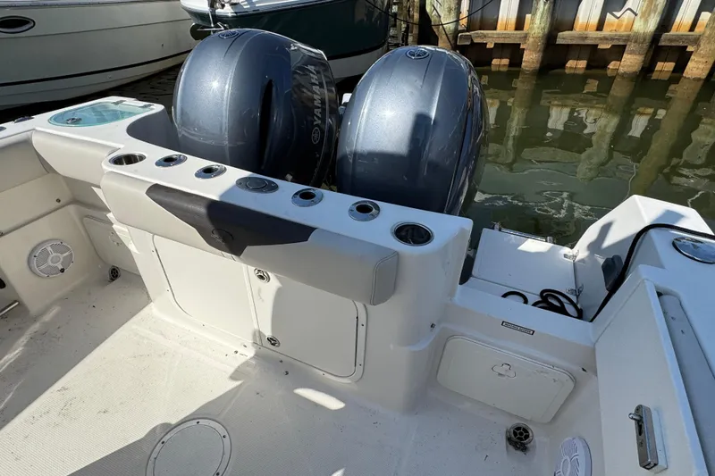 Slide: The Image of 2022 Sailfish 242 CC boat with dual Yamaha outboard engines docked at marina. - 27