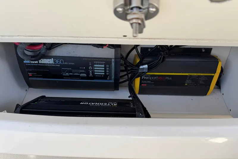 Slide: The Image of Marine battery chargers in a 2022 Sailfish 242 CC boat compartment. - 30