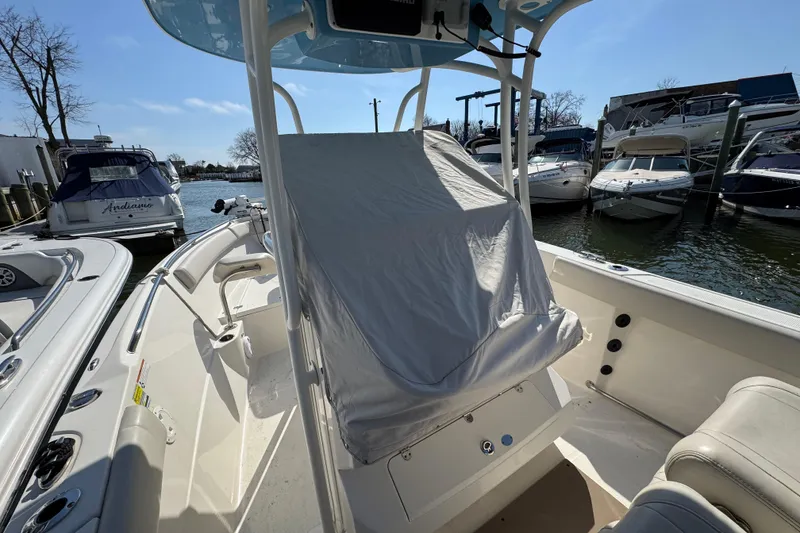 Slide: The Image of 2022 Sailfish 242 CC boat docked, interior view with covered console. - 31