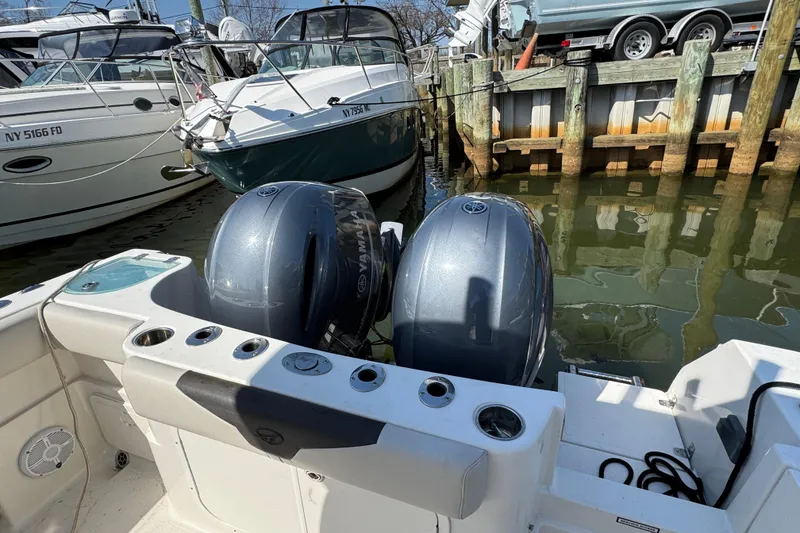 Slide: The Image of 2022 Sailfish 242 CC boat with dual Yamaha outboard motors docked at marina. - 5