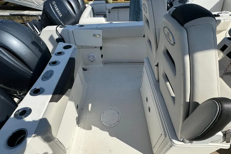 Slide: The Image of 2022 Sailfish 242 CC boat interior with Yamaha engines and seating area. - 6