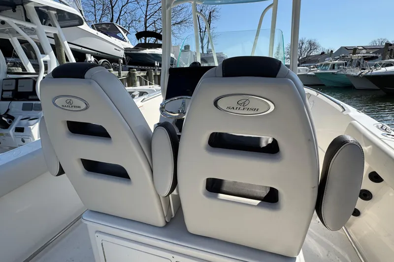 Slide: The Image of Interior of 2022 Sailfish 242 CC boat with dual cushioned seats and sleek design. - 7