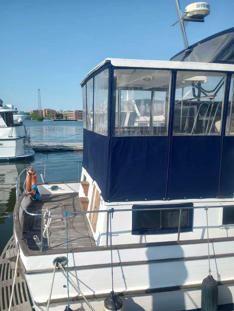 Slide: The Image of 1981 Marine Trading 44 Double Cabin at dock, blue sky. - 2