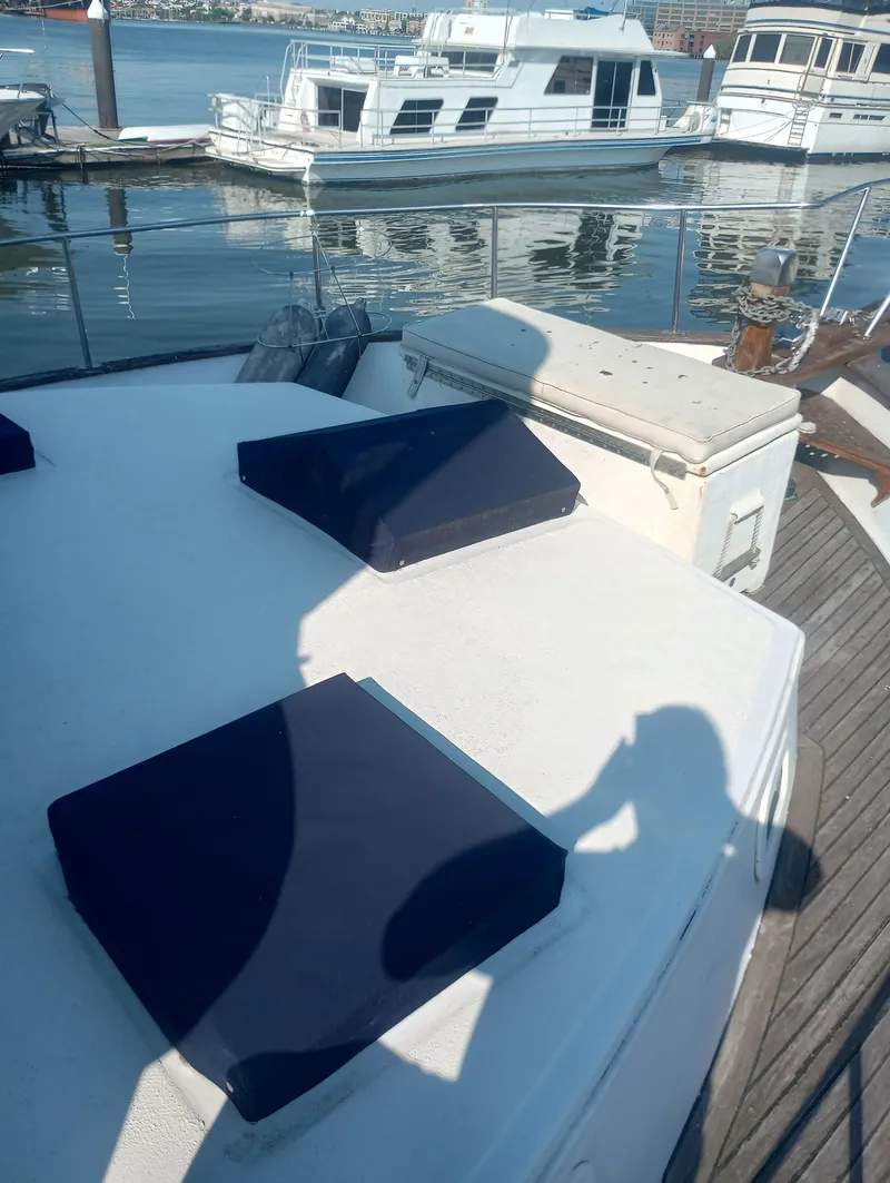 Slide: The Image of 1981 Marine Trading 44 Double Cabin in a serene harbor. - 3