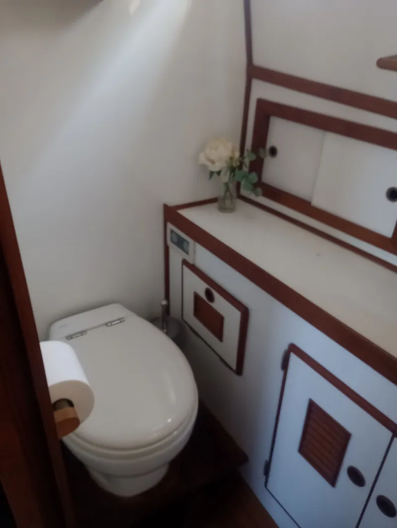 Slide: The Image of Marine Trading 44 Double Cabin 1981 bathroom with toilet and cabinet. - 31