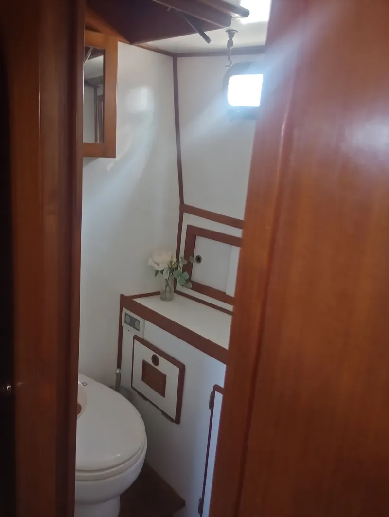 Slide: The Image of Marine Trading 44 Double Cabin 1981 bathroom with wood paneling. - 33