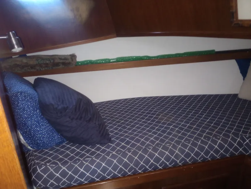 Slide: The Image of Interior of 1981 Marine Trading 44 Double Cabin with cozy bed. - 35