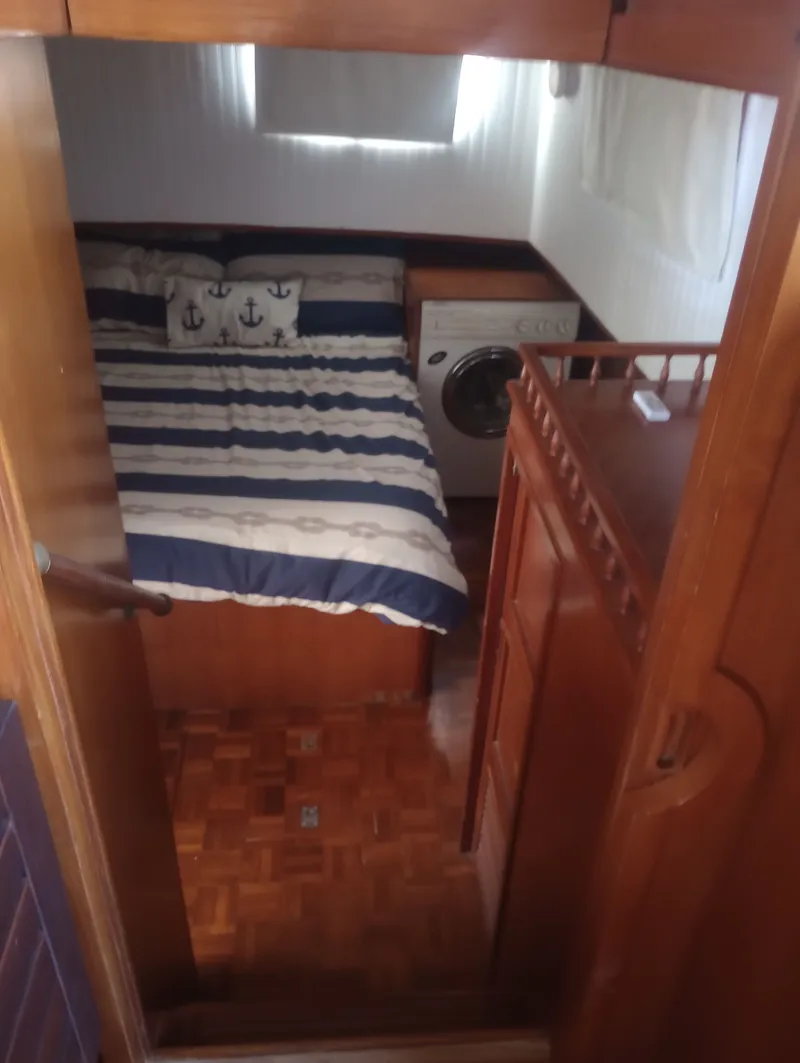 Slide: The Image of Interior of a 1981 Marine Trading 44 Double Cabin with bed and washing machine. - 37