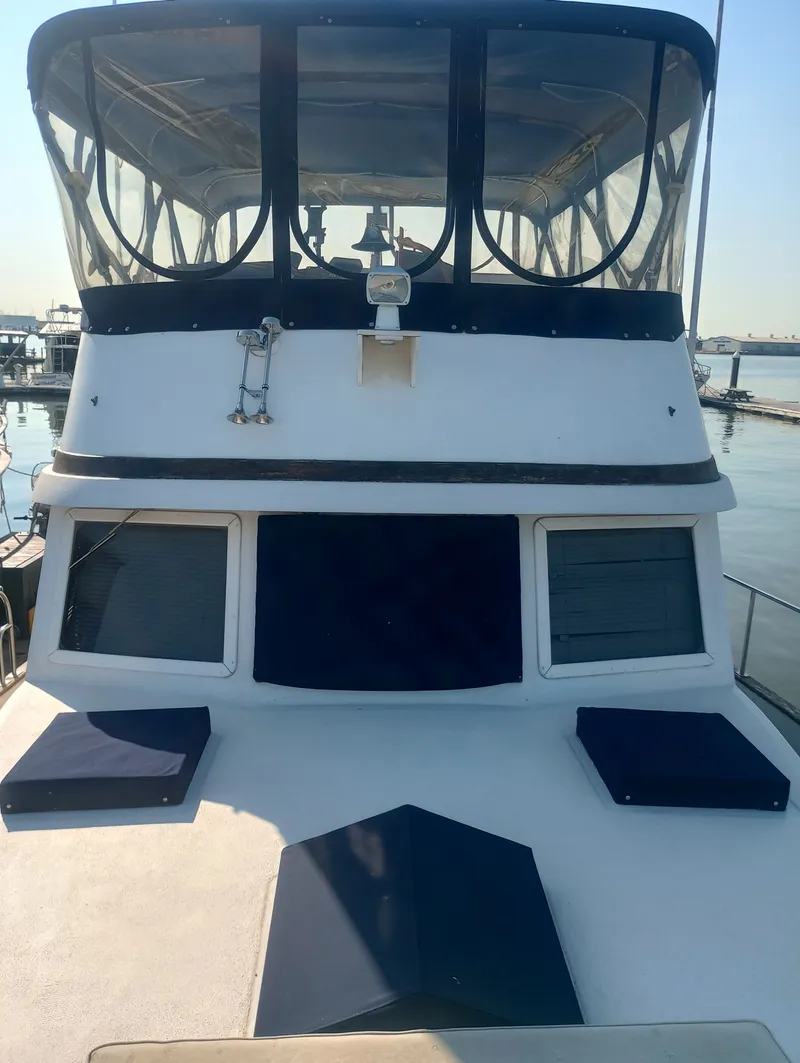 Slide: The Image of 1981 Marine Trading 44 Double Cabin on the water. - 5