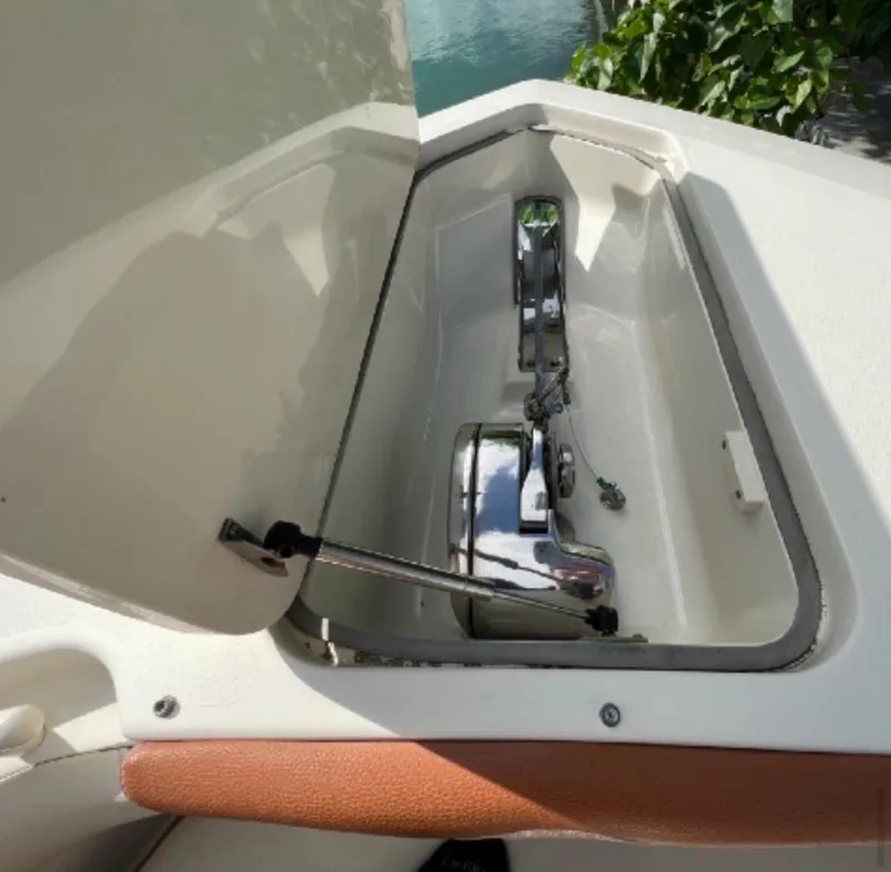 Slide: The Image of Anchor compartment of 2013 Scout 275 LXF boat, open lid, showing anchor mechanism. - 10