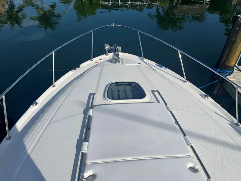 Slide: The Image of 2008 Sea Ray 340 Sundancer boat deck with railing, docked on calm water. - 5