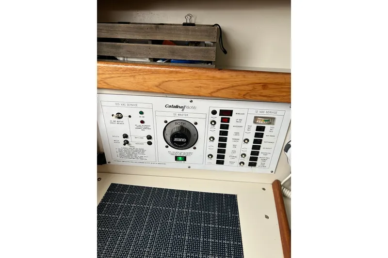 Slide: The Image of Electrical control panel of a 1994 Catalina 270 sailboat, featuring various switches and indicators. - 14