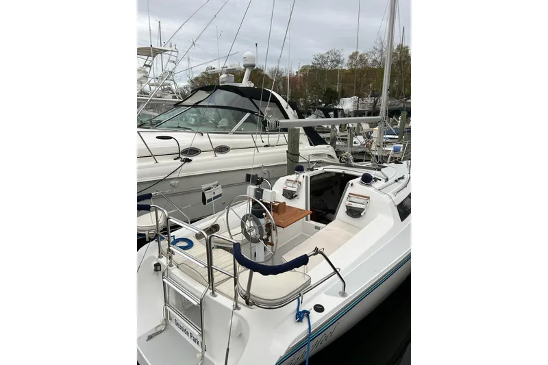 Slide: The Image of 1994 Catalina 270 sailboat docked, featuring a spacious cockpit and sleek design. - 7