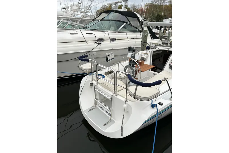 Slide: The Image of 1994 Catalina 270 sailboat docked, featuring a spacious cockpit and sleek design. - 8