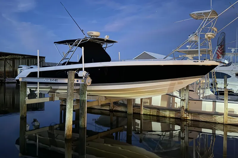 Slide: The Image of 2008 Donzi 35 ZR Open boat docked at marina during twilight. - 10