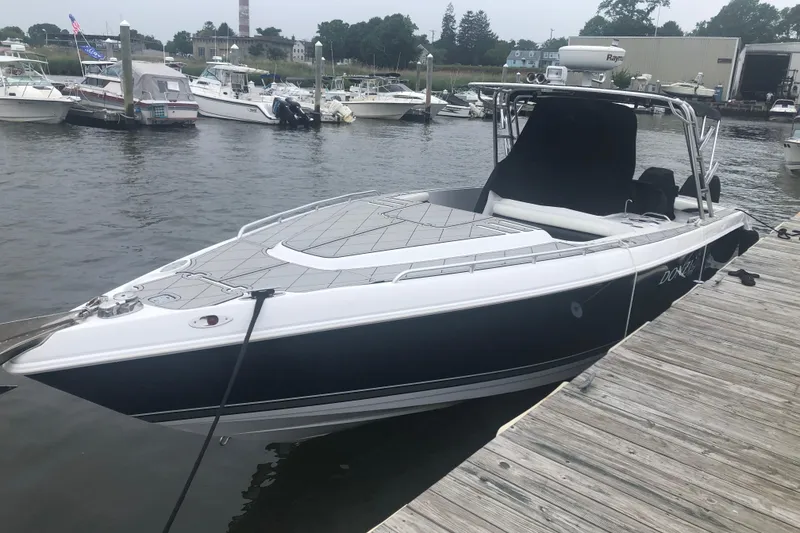 Slide: The Image of 2008 Donzi 35 ZR Open boat docked at a marina, surrounded by other vessels. - 3