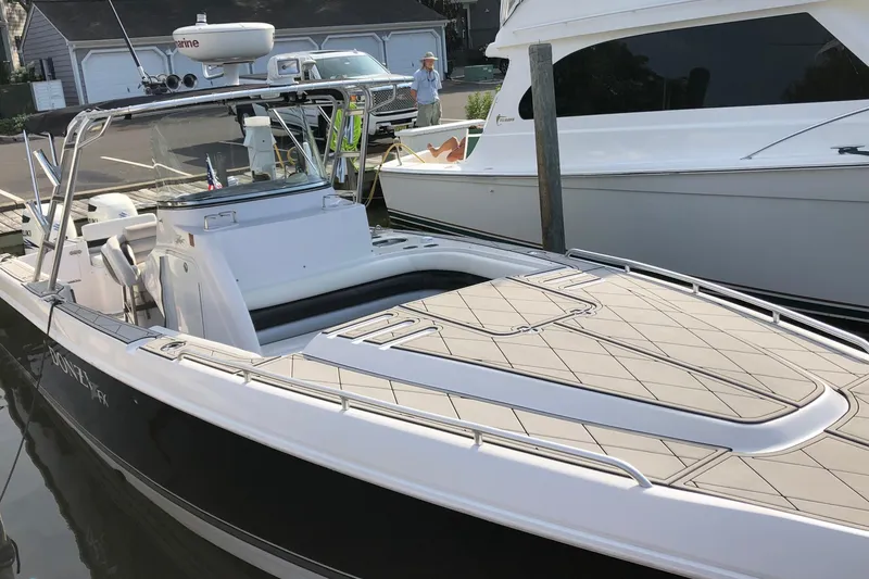Slide: The Image of 2008 Donzi 35 ZR Open boat docked, featuring sleek design and spacious deck. - 4