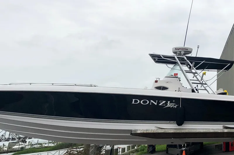 Slide: The Image of 2008 Donzi 35 ZR Open boat on display, featuring sleek black and white design. - 7