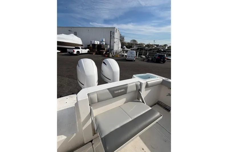 Slide: The Image of 2017 Everglades 255 Center Console boat with dual engines in a marina setting. - 10