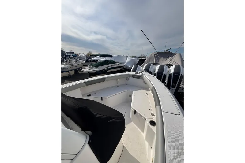 Slide: The Image of 2017 Everglades 255 Center Console boat docked, showcasing spacious deck and sleek design. - 11