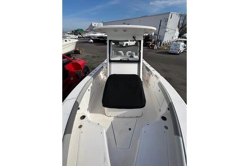 Slide: The Image of 2017 Everglades 255 Center Console boat in a marina setting. - 16