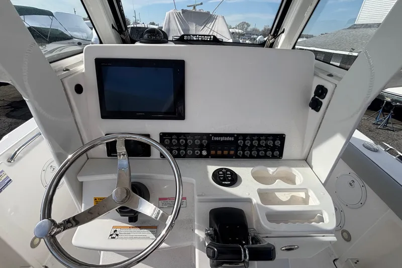Slide: The Image of 2017 Everglades 255 Center Console helm with steering wheel, controls, and navigation display. - 22