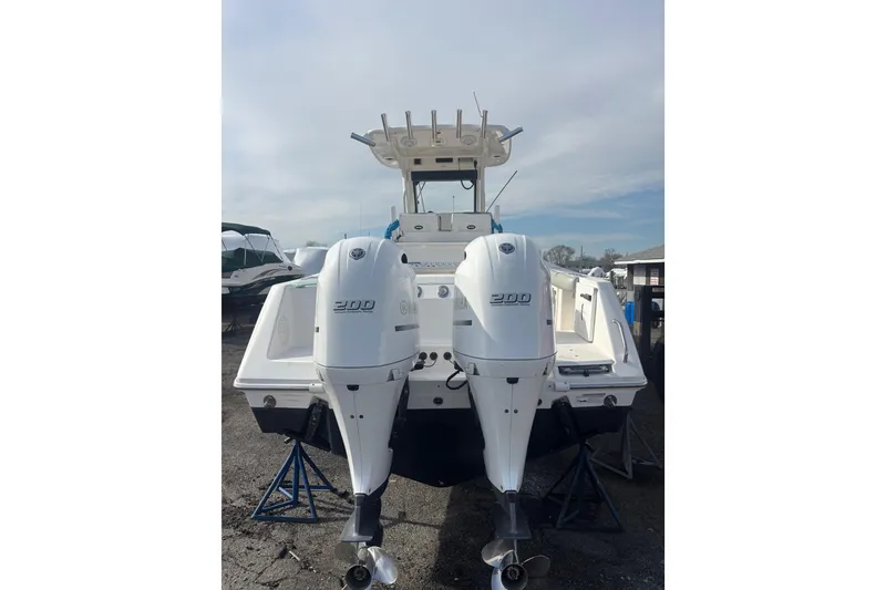 Slide: The Image of 2017 Everglades 255 Center Console boat with twin 200 horsepower engines, docked outdoors. - 5