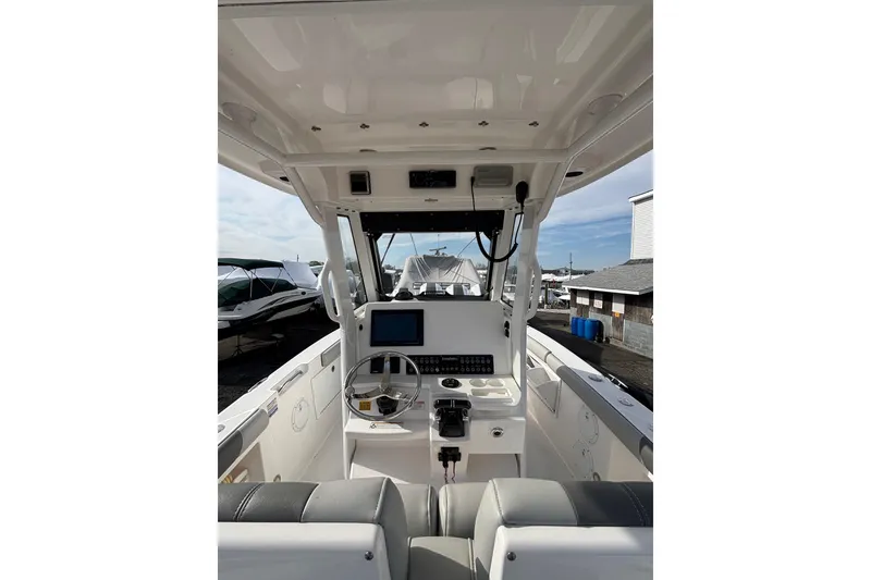 Slide: The Image of 2017 Everglades 255 Center Console boat interior with steering wheel and control panel. - 6