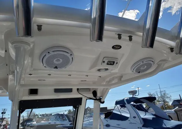 Slide: The Image of 2017 Everglades 255 Center Console boat interior with speakers and rod holders. - 7