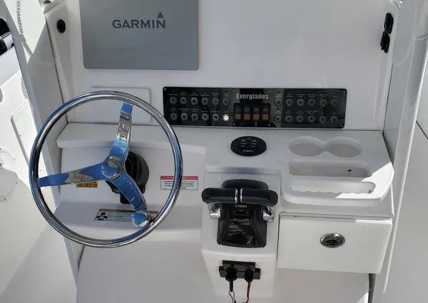Slide: The Image of 2017 Everglades 255 Center Console helm with Garmin navigation and control panel. - 8