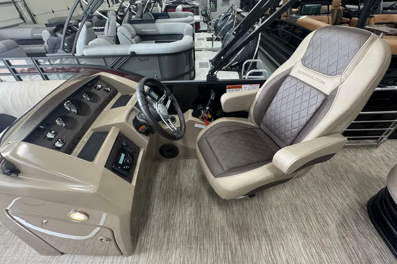 Slide: The Image of 2024 Bennington 24 L Swingback boat interior with captain's chair and control panel. - 14