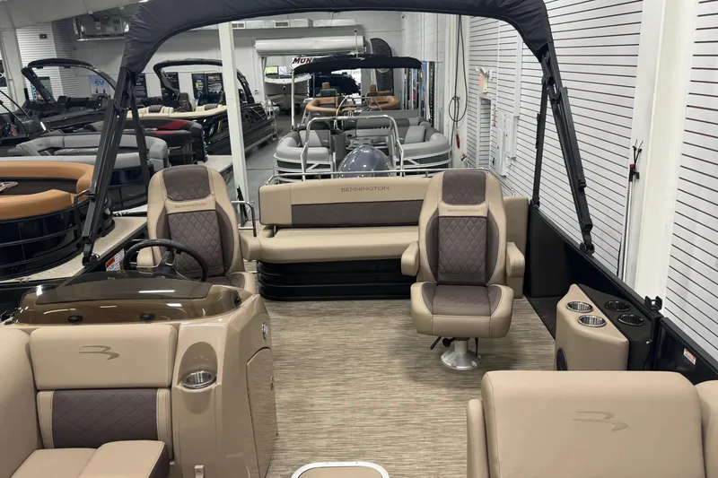Slide: The Image of 2024 Bennington 24 L Swingback pontoon boat interior with luxurious seating and helm. - 16