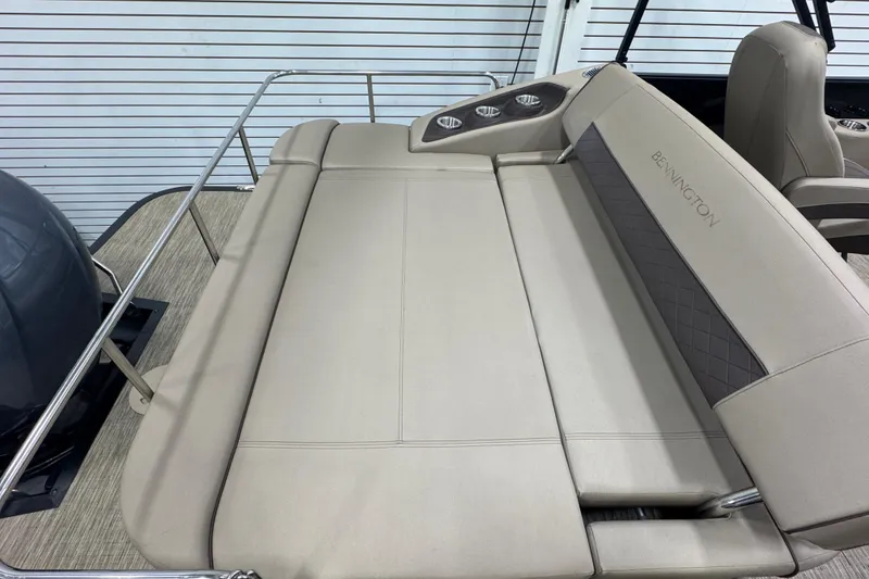 Slide: The Image of 2024 Bennington 24 L Swingback boat with beige seating and cup holders. - 18