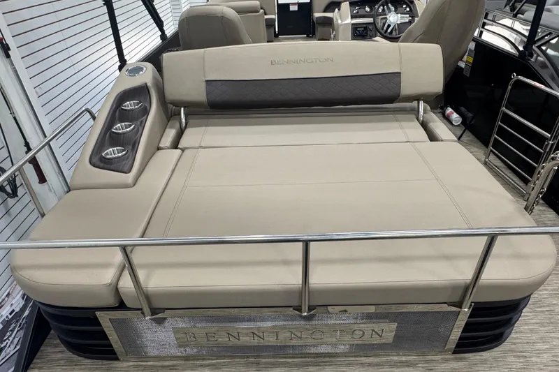 Slide: The Image of 2024 Bennington 24 L Swingback boat interior with beige seating and cup holders. - 19