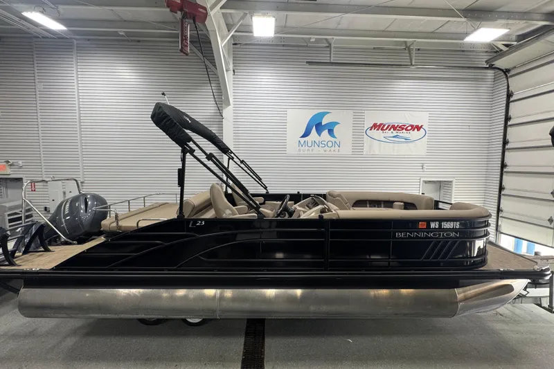 Slide: The Image of 2024 Bennington 24 L Swingback pontoon boat in showroom, side view. - 2
