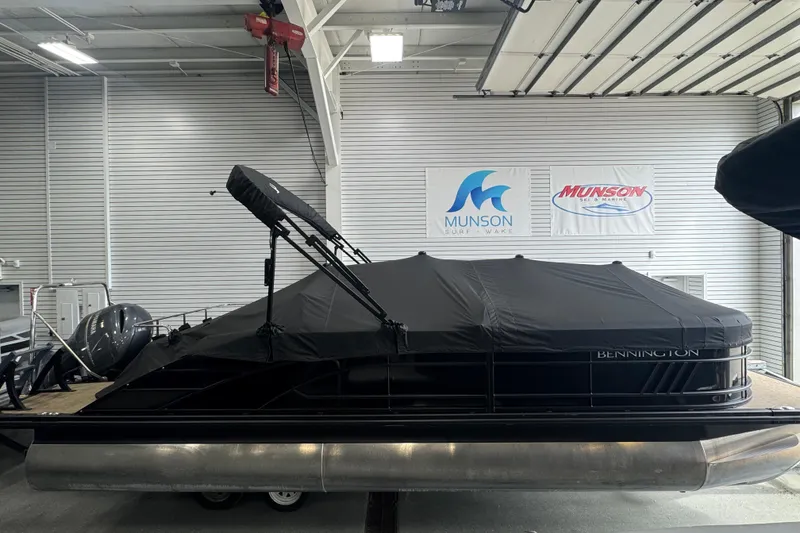 Slide: The Image of 2024 Bennington 24 L Swingback pontoon boat with cover in showroom. - 26