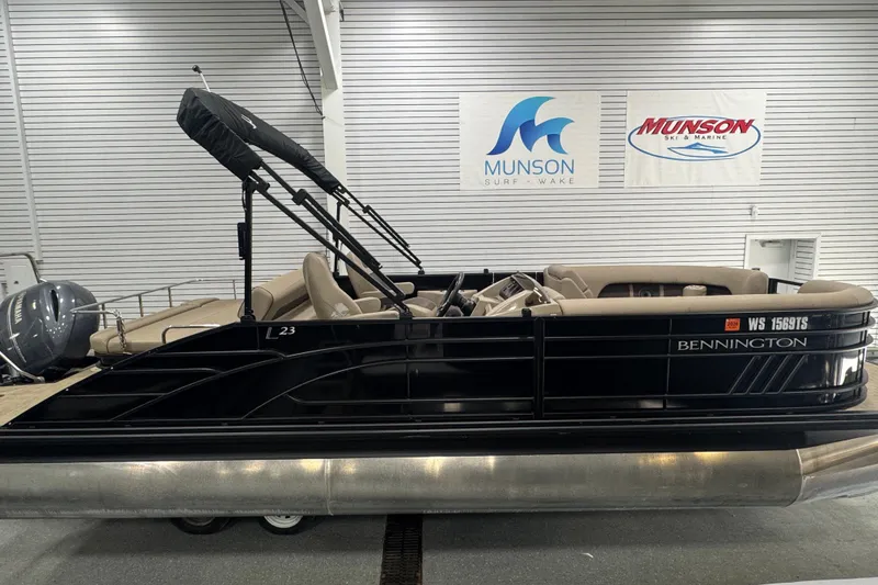 Slide: The Image of 2024 Bennington 24 L Swingback pontoon boat displayed indoors at Munson Ski & Marine. - 3