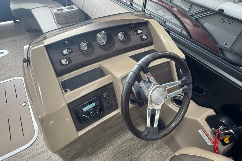 Slide: The Image of 2024 Bennington 24 L Swingback boat dashboard with steering wheel and control panel. - 7