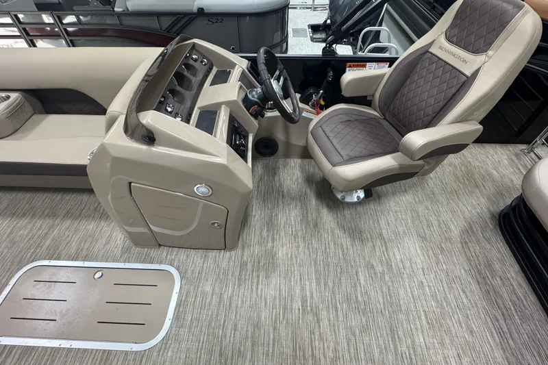 Slide: The Image of 2024 Bennington 24 L Swingback boat interior with captain's chair and control panel. - 8
