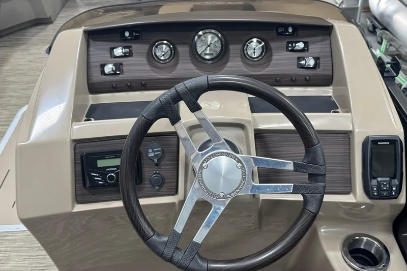 Slide: The Image of 2024 Bennington 24 L Swingback boat dashboard with steering wheel and control panel. - 9