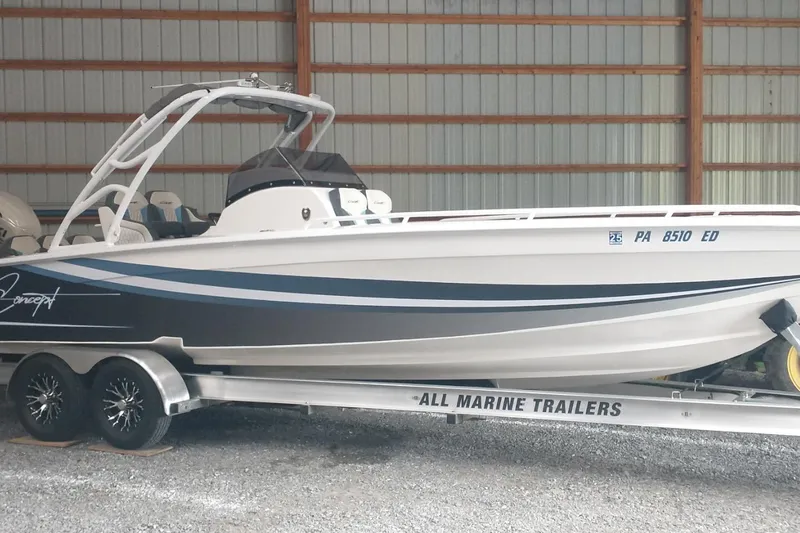 The Image of 2019 Concept 30' Open Deck boat on trailer in storage facility. - 1