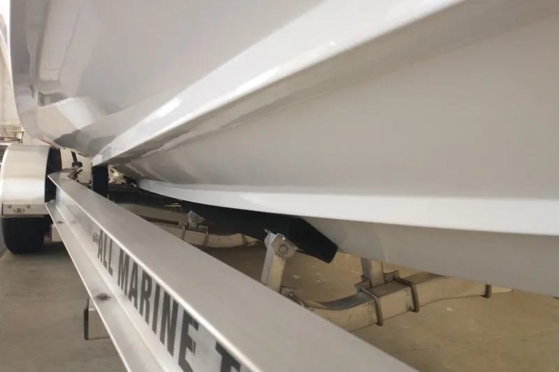 Slide: The Image of 2019 Concept 30' Open Deck boat on trailer, close-up view of hull and support. - 15