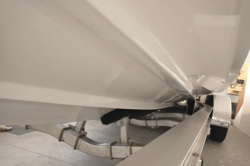 Slide: The Image of 2019 Concept 30' Open Deck boat on trailer, viewed from below in a garage. - 17