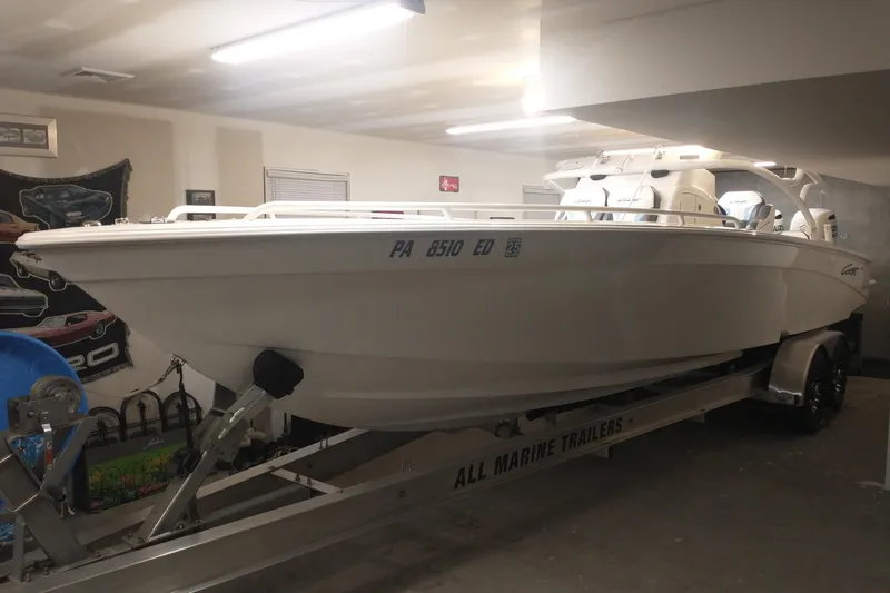 Slide: The Image of 2019 Concept 30' Open Deck boat on trailer in garage setting. - 18