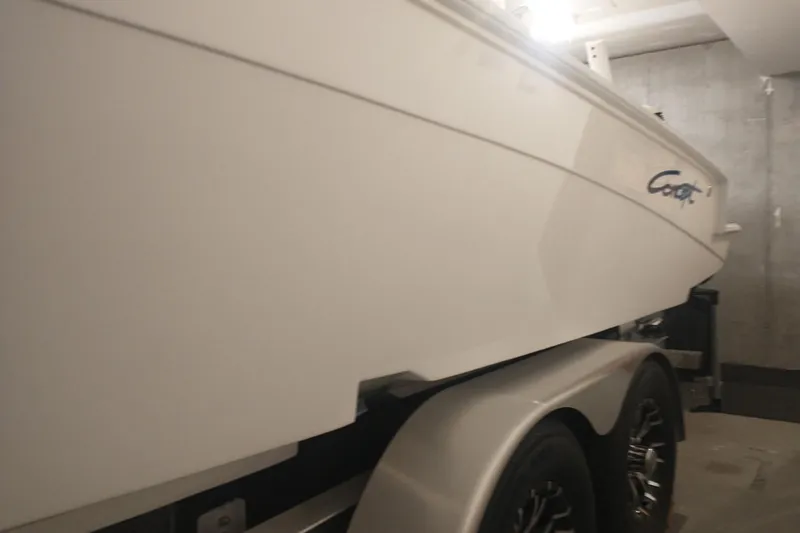 Slide: The Image of 2019 Concept 30' Open Deck boat on trailer in garage setting. - 19