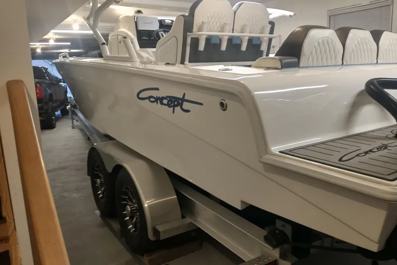 Slide: The Image of 2019 Concept 30' Open Deck boat in garage, featuring sleek design and modern seating. - 20