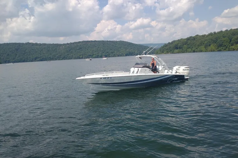 Slide: The Image of 2019 Concept 30' Open Deck boat cruising on a scenic lake with forested hills. - 3