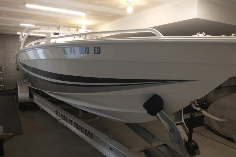 Slide: The Image of 2019 Concept 30' Open Deck boat on trailer in garage setting. - 6